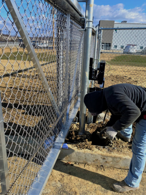 man fixing a gate
